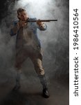 Small photo of Man in uniform of an officer of Patriots of Revolutionary War with musket. Historical concept of 4th of July USA