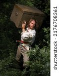 Small photo of Sea robber ship captain armed pirate goes through jungle with chest of treasures. Concept historical halloween. Filibuster cosplay.