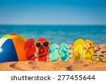 Flip-flops, beach ball and snorkel on the sand. Summer vacation concept