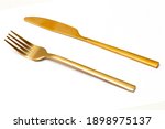Top view of golden Slicing knife and fork isolated white background.