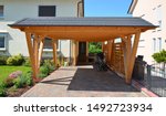 Small photo of New wooden Carport in Front of a residential Building