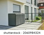 Small photo of Modern Metal Tool Shed, Bike Shed or Garden Shed or Garbage collection system with in Front of a residential building