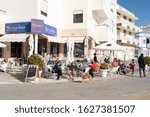 Small photo of Armacao de Pera, Portugal - Jan 25th, 2020 - Local bistro and tourists inside of it enjoying food and drinks near the waterfront area of Armacao de Pera. Cafe in Armacao de Pera.