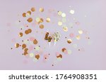 Small photo of Birthday candle in the form of number 49 decorated with colored confetti on a pink background. Postcard to the forty-ninth anniversary.