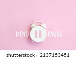 Small photo of Word Menopause, pause sign on a white alarm clock on pink background. Minimal concept hormone replacement therapy. Đˇopy space