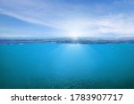 Small photo of BLUE UNDER WATER waves and bubbles. Beautiful white clouds on blue sky over calm sea with sunlight reflection, Tranquil sea harmony of calm water surface. Sunny sky and calm blue ocean.