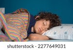 Small photo of Boy child 8 years old sleeping at home in bedroom apartment - lifestyle in childhood - sleep in deep sleep and wake up to go to school and start the day