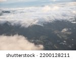 Ariel view of mountains and clouds over villages in Costa Rica