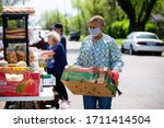 Small photo of Sherman, TX / United States - April 1 2020: Members of the St John's Christian Methodist Episcopal Church in Sherman, TX, host a drive- up food pantry on April 1, 2020.