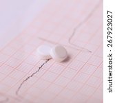 Small photo of Cardiogram and nitroglycerin, the concept for strokes and heart attacks