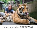 Young Man Hugging A Big Tiger...
