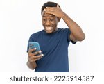 Small photo of Embarrassed man looking at smartphone. Young African American male model in blue T-shirt checking phone seeing something surprising. Portrait, studio shot, technology, embarrassment concept