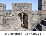 Small photo of Arrow slit, crosslet loop or an arbalestina, in a merlon on top of the donjon, also called the keep, of the castle in Braganca, Portugal