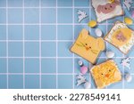 Cute funny Easter breakfast for kids. Homemade sandwiches, sandwiches in the form of symbols of the Easter holiday - Sheep, bunny rabbit, Easter egg, chicken.  top view copy space