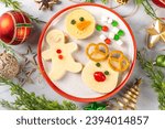 Christmas breakfast cheese sandwiches in form of xmas holiday festive symbols - gingerbread man, reindeer, snowman, top view copy space. Funny kids New Year and Christmas snack, lunch idea