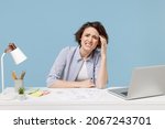 Small photo of Young confused disappointed troubled secretary employee business woman in casual shirt sit work at white office desk with pc laptop prop up forehead isolated on pastel blue background studio portrait