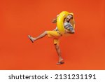 Small photo of Full body young tourist man wear beach shirt hat hold inflatable ring lean back raise up leg fooling around isolated on plain orange background studio portrait Summer vacation sea rest sun tan concept