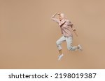 Small photo of Full body fun young arabian asian muslim woman she wearing abaya hijab pink clothes jump high look far away distance isolated on plain pastel light beige background. People uae islam religious concept