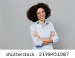 Small photo of Young fun employee business corporate lawyer woman of African American ethnicity in classic formal shirt work in office hold hands crossed folded look camera isolated on grey color background studio