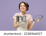 Small photo of Young satisfied happy housewife housekeeper chef cook baker woman in pink apron holding soup stainless pan saucepan sniff smell isolated on pastel violet background studio Cooking food process concept