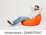 Small photo of Full body young minded dreamful happy smiling man wear mint hoody sit in bag chair look camera hold hands behind neck isolated on plain solid white background studio portrait People lifestyle concept