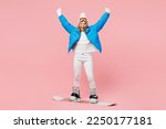 Snowboarder woman wear blue suit goggles mask hat ski padded jacket snowboarding do winner gesture wink isolated on plain pastel pink background. Winter extreme sport hobby weekend trip relax concept