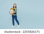 Small photo of Full body profile young woman wear casual clothes hold brown paper bag with food products look aside on area isolated on plain blue background studio portrait. Delivery service from shop or restaurant