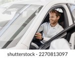 Satisfied smiling man customer buyer businessman client in classic suit sit in car salon chooses auto wants buy new automobile in showroom vehicle dealership store motor show indoor Car sales concept