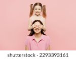 Small photo of Happy woman wear casual clothes with child kid girl 6-7 years old. Mother daughter close eyes with hands play guess who or hide and seek isolated on plain pink background. Family parent day concept