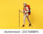 Small photo of Full body sideways young woman carry bag with stuff mat hold trekking poles isolated on plain yellow background. Tourist leads active lifestyle walk on spare time Hiking trek rest travel trip concept
