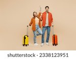 Small photo of Traveler couple two friend family man woman wear casual clothes holding passport ticket bag isolated on plain beige background. Tourist travel abroad in free time rest getaway. Air flight trip concept