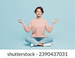 Small photo of Full body young woman she wear beige knitted sweater casual clothes sit hold spreading hands in yoga om aum gesture relax meditate try to calm down isolated on plain pastel light blue cyan background