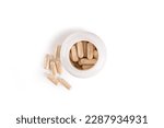 Small photo of Top view of Supplement pills in white plastic bottle on white background. Dietary supplement