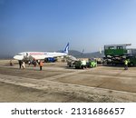 Small photo of Sabiha Gokcen Airport, Istanbul, Turkey - January 15, 2022: Passengers boarding by outdoor stairs a airplane of ANADOLU JET, subsidiary of Turkish Airlines. HAVAS ground staff carrying luggage.