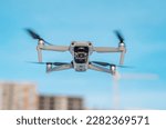 Drone quadcopter against a blue sky. Air shooting, aerial reconnaissance