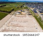 Small photo of Aerial shots of a developing housing estate in the outer suburbs of Melbourne Australia, roads and gutters have been built, plots of land some already sold are almost ready for houses to be built.