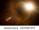 Small photo of Easy to add lens flare effects for overlay designs or screen blending mode to make high-quality images. Abstract sun burst, digital flare, iridescent glare over black background.