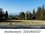 Small photo of Vancouver, Canada - October 14,2022: View of cyclist on Marine Dr HW near University of British Columbia