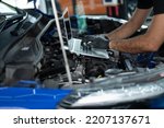 Small photo of Mechanic Asian Arab man close up using laptop computer and diagnostic software to tuning fixing repairing car engine automobile vehicle parts using tools equipment in workshop garage support services