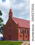 Small photo of KRASNOLESYE, RUSSIA - JUNE 12, 2016: Old red bricks church in Krasnolesye village (former Gross Rominten) of Kaliningrad Oblast. Now is the russian orthodox church of Holy Martyrs Adrian and Natalia.