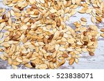 dried in the oven pumpkin seeds on a white wooden background shabby