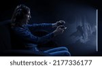 Small photo of A woman in headphones with a controller set aside in her hands