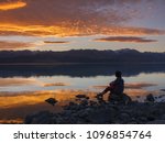 dreamer, silhouette of woman sitting along the lake at sunset, human strength, psychology concept