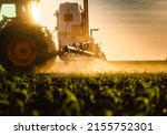 Tractor spraying pesticides on...