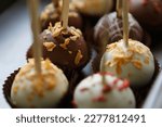 Delicious chocolate bon bon sweets on sticks prepared with Belgian milk chocolate