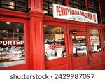 Small photo of Pittsburgh, PA USA - 4 2 2022: In Pittsburgh, PA, the iconic Pennsylvania Macaroni shop boasts its timeless charm with a vibrant red facade in the historic Strip District.