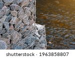 Small photo of Gabion and rock armour - coastal and waterways protection. Gabion walls constructed using steel wire mesh basket. Stone wall, gabion revetment - protection from backshore erosion.