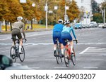 Small photo of Minsk, Belarus. Jul 16, 2022. City road cycling team, men and woman cyclists ride together in urban environment as united sport squad, illustrating team spirit, sportsmanship. Cyclist in racing outfit