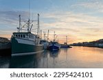 Small photo of Fishing boats moored at the dock at sunset during the winter, Port de Grave, Newfoundland and Labrador, Canada.