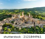 Aerial view of famous medieval San Gimignano hill town with its skyline of medieval towers, including the stone Torre Grossa. UNESCO World Heritage Site. Province of Siena, Tuscany, Italy.